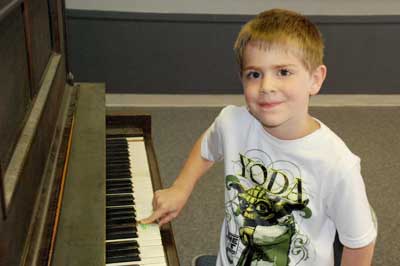 kid playing piano